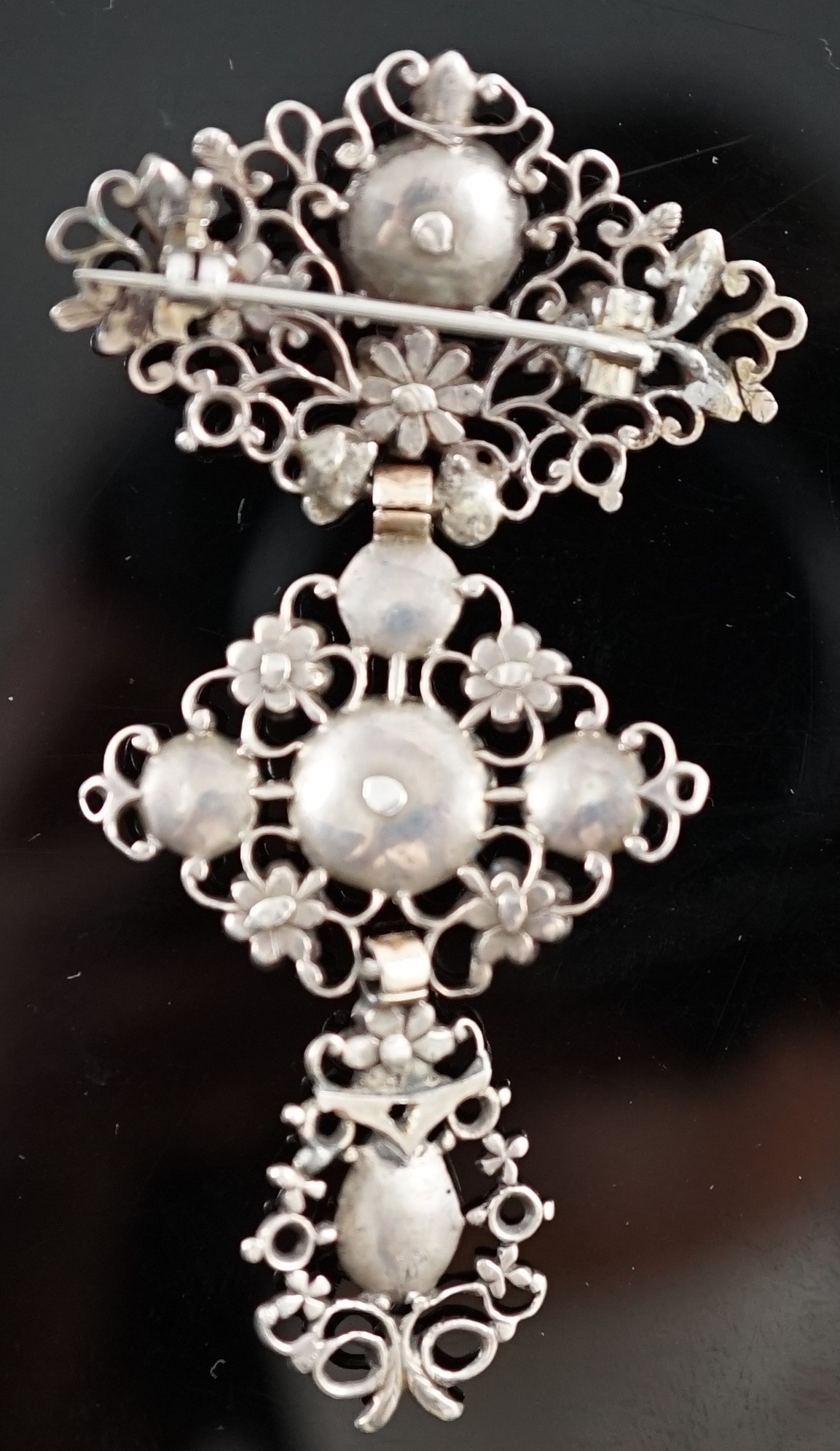 An antique pierced gold, silver and diamond set drop brooch